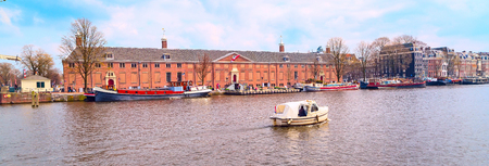 Traditional old buildings, canal and boat view in Amsterdam, the Netherlandsの写真素材