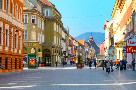 Brasov, Romania - March 24, 2015: People at the pedestrian street Republicii and Black church at downtownのeditorial素材