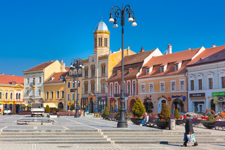 Brasov, Romania - March 24, 2015: The Orthodox Church of the Birth of the Mother of God at Council Square -Piata Sfatului - in downtown of Brasov and people near itのeditorial素材
