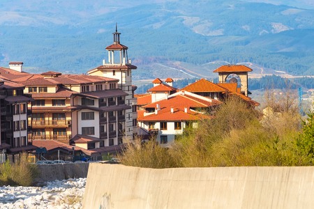 Bansko, Bulgaria spring view with trees, mountains landscape and house towerの写真素材