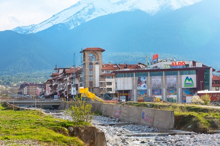 Bansko, Bulgaria - April 14, 2017: Spring view with river Glazne, mountains landscape, Bansko Mall and house towerのeditorial素材