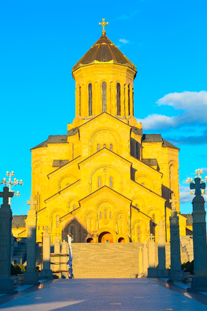 Holy Trinity church or Tsminda Sameba Cathedral closeup sunset vertical photo, Tbilisi, Georgia