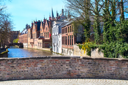 scenic cityscape with houses, part of bridge and Green canal, Groenerei in Bruges, Belgiumの写真素材