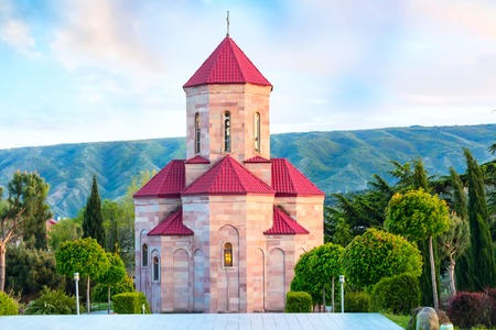 Chapel near Holy Trinity church or Tsminda Sameba Cathedral with colorful clouds in Tbilisi, Georgia