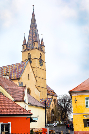 Sibiu, Romania - March 27, 2015: Church tower and people walking at rainy weather in Sibiu, Transylvania, Romaniaのeditorial素材