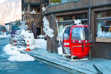 Chamonix, France - January 25, 2015: Old red cable car cabin in the street and white christmas treesのeditorial素材
