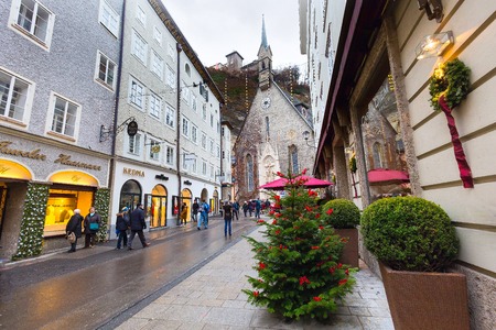Salzburg, Austria - December 25, 2016: Christmas tree and historical center street with peopleのeditorial素材