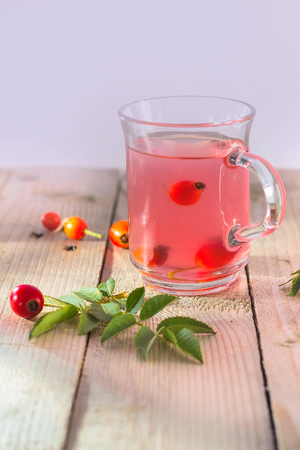 Tea herbal drink from rose hips in glass cup on wooden backgroundの写真素材