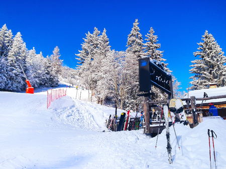 Chamonix, France - January 25, 2015: Ski slopes in the mountains of Les Houches winter resort, in French Alps with snowy trees, restaurant and skisのeditorial素材