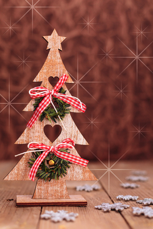 Christmas or New Year background with wooden christmas tree, decorations and copy spaceの写真素材