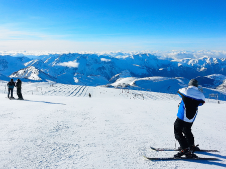 Les Deux Alpes, France - December 30, 2012: Ski resort slopes, skier making photo, mountain panorama in France, French Alpsのeditorial素材