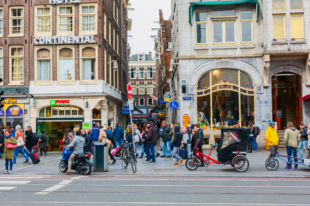 Amsterdam, Netherlands - March 31, 2016: Street view with people and bicycles in city centre of Amsterdam, Hollandのeditorial素材