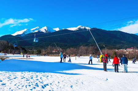 Bansko, Bulgaria - January 3, 2018: Winter ski resort Bansko, ski slope, people skiing and mountains viewのeditorial素材