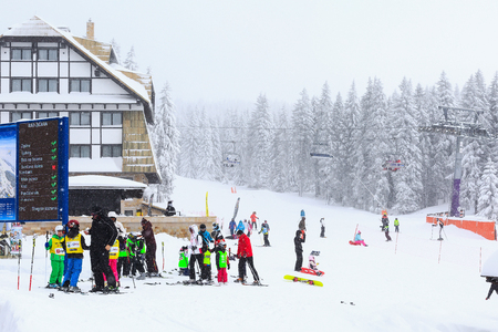 Kopaonik, Serbia - January 18, 2016: Panorama of winter ski resort Kopaonik during snowfall, skiers and snowy treesのeditorial素材