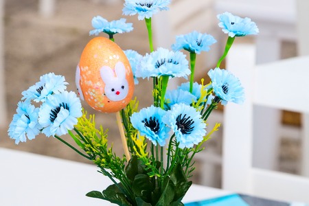 easter egg in vase with blue flowers, easter decorations holiday background