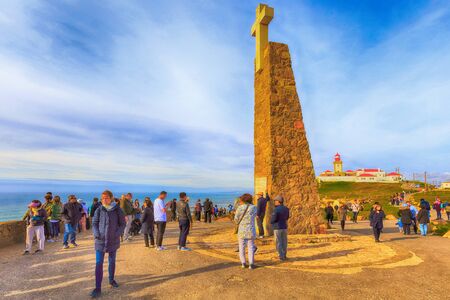 Cabo da Roca, Portugal - March 28, 2018: Monument declaring Cabo da Roca as the westernmost extent of continental Europe and people taking photosのeditorial素材