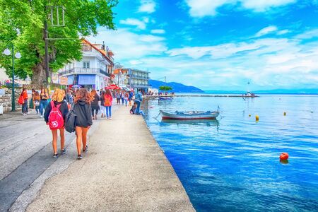 Thassos, Greece - May 5, 2018: Thasos port with lighthouse and promenade view with peopleのeditorial素材