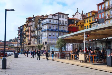Porto, Portugal -April 1. 2018: Old town Ribeira promenade view and peopleのeditorial素材