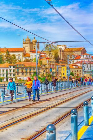 Porto, Portugal -April 1. 2018: Old town Ribeira view and people on Luis I bridgeのeditorial素材