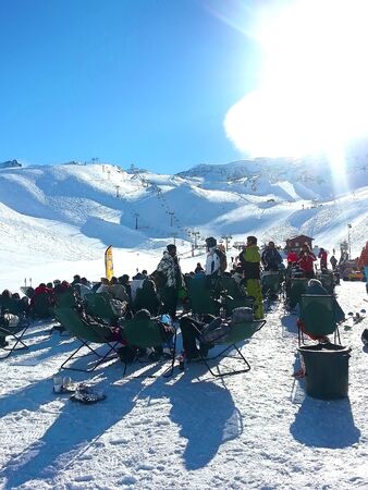 Les Deux Alpes, France - January 5, 3013: Ski resort bar, people and slopes aerial view, France,...