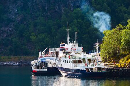 Flam, Norway - July 31, 2018: Norwegian village at Sognefjord fjord, ships and cruise boatsのeditorial素材