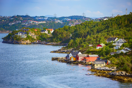 Norwegian scandinavian scenic landscape with fjord water, mountains and colorful traditional housesの写真素材