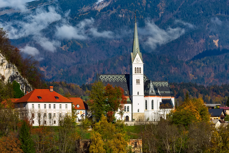 View of Bled with Church, Slovenia. Autumn colorful trees backgroundの写真素材