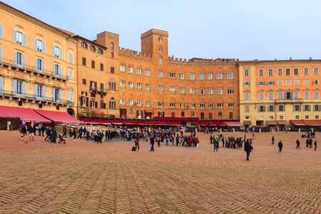 Siena, Italy - October 25, 2018: Panorama of Campo Square or Piazza del Campo with cafe, restaurants and people in Tuscany townのeditorial素材