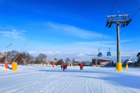 Bansko, Bulgaria - January 22, 2018: Winter ski resort Bansko with ski slope, lift cabins, people and mountains viewのeditorial素材