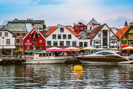 Stavanger, Norway - August 2, 2018: City street view with people, harbour and colorful traditional wooden housesのeditorial素材