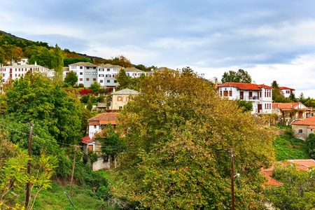 Colorful autumn trees and Portaria mountain village aerial view, Pelion, Greece