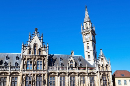 Details of old Post Office building with the clock tower against blue sky in Ghent, Belgiumの写真素材