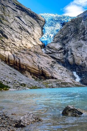 Norway, Olden landmark nature gem, lake and Briksdal or Briksdalsbreen glacier with melting blue iceのeditorial素材