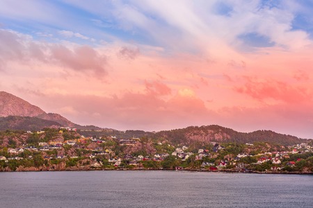 Norwegian colorful landscape with sunset over fjord and mountain village, Norwayの写真素材