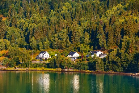 Norwegian village landscape with fjord, mountains and houses in Olden, Norwayの写真素材
