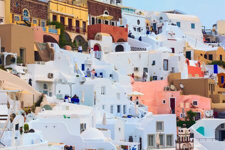 Oia, Santorini - April 25, 2019: Famous village in cyclades Island with colorful houses and tourists