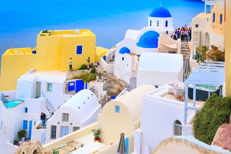 Oia, Santorini - April 25, 2019: Famous village in cyclades island with colorful houses, church...