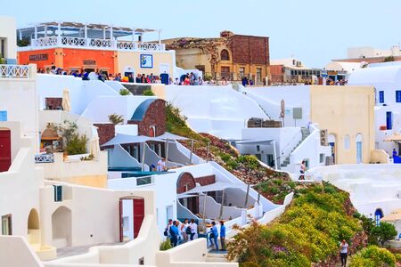 Oia, Santorini - April 25, 2019: Famous village in cyclades island with colorful houses and touristsのeditorial素材