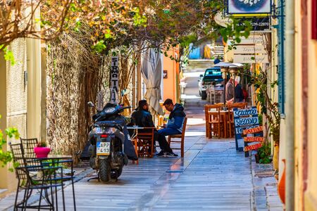 Nafplio, Greece - March 30, 2019: Old town street panorama with cosy cafe in Nafplion, Peloponneseのeditorial素材