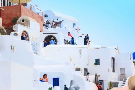 Oia, Santorini, Greece - April 25, 2019: Famous village in cyclades island with colorful houses and touristsのeditorial素材