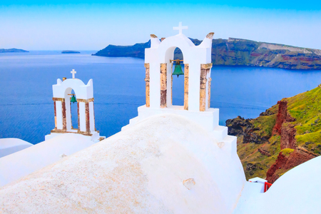 Sea and iconic view of white church bell tower, Santorini, Oia, Greeceの写真素材