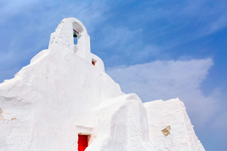 Mykonos, Greece landmark, white Paraportiani Church on famous greek island, close-up on blue sky backgroundの写真素材
