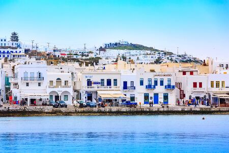 Mykonos, Greece - April 23, 2019: Famous island white houses, promenade, beach, view from the sea in Cycladesのeditorial素材