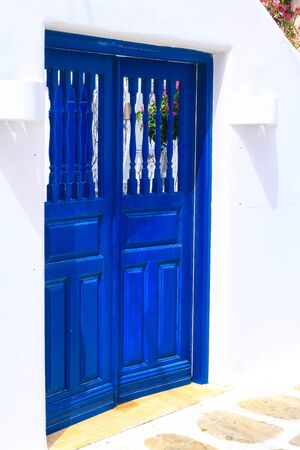 Greek traditional architecture, street view with white and blue house door close-upの写真素材