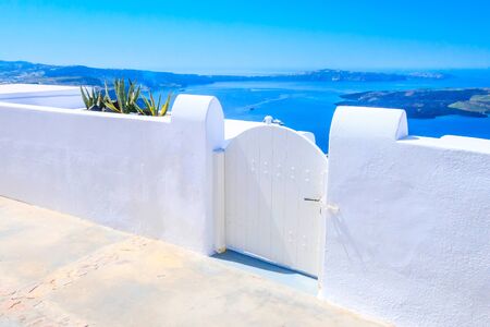 Santorini island, Greece architecture, white door with caldera blue sea panoramic view and volcano islandの写真素材