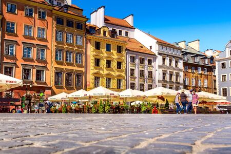 Warsaw, Poland - June 24, 2019: Colorful houses and people in Market Square in the Old Town of...