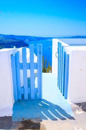 Santorini island, Greece architecture, blue door with caldera blue sea panoramic view and volcano islandの写真素材