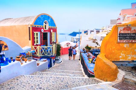 Santorini, Greece - April 26, 2019: Oia village street view and colorful houses, peopleのeditorial素材