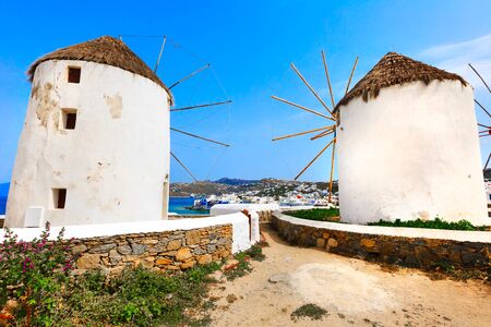 Greek iconic windmills and little venice panorama in Mykonos, Greece, famous island in Cycladesの写真素材