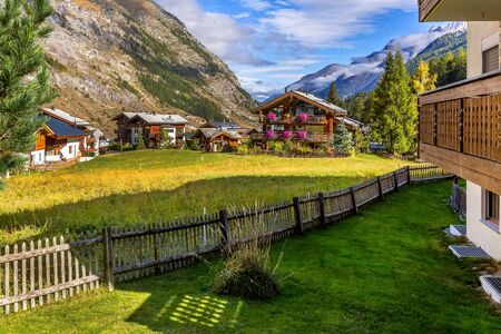 Traditional wooden houses, flowers in Zermatt, alpine village panorama, Switzerland, Swiss Alps and...